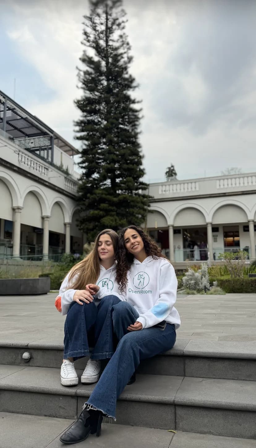 Two OpenRoom ambassadors wearing branded hoodies in a courtyard