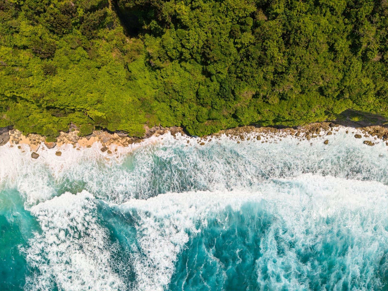 Aerial coastline with green cliffs and bright water