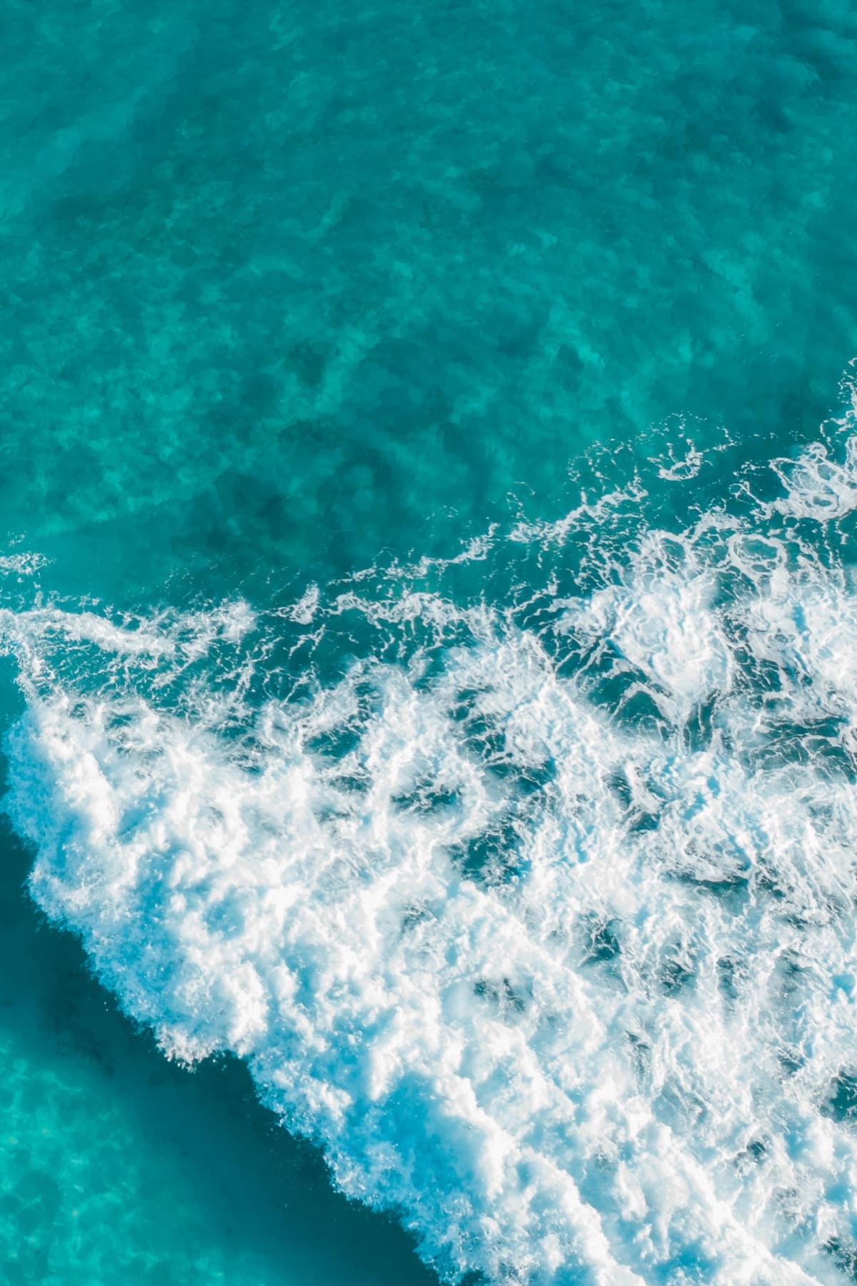 Turquoise ocean waves from above